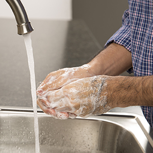 Primer plano de manos que se lavan con agua y jabón.
